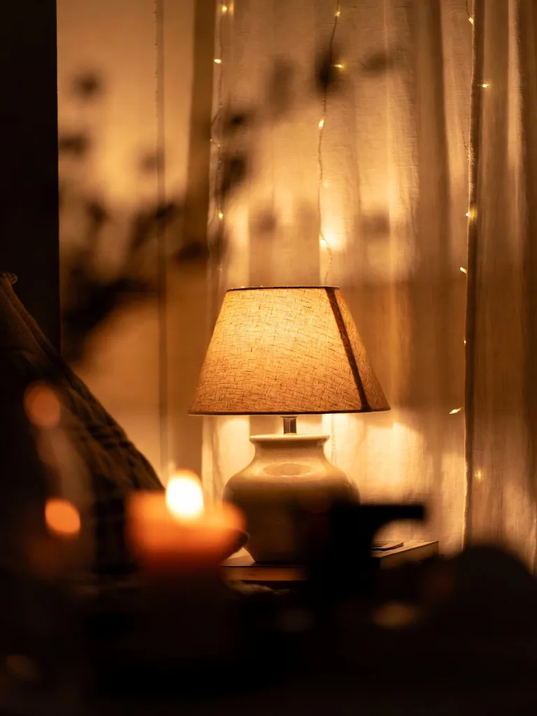 A bedroom bathed in warm, dimmable lighting, creating a soft and cozy atmosphere with plush bedding. Cozy bedroom ideas....