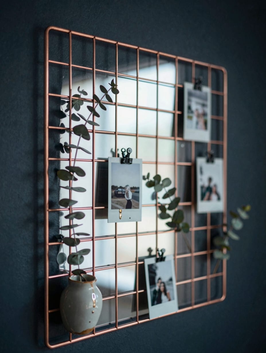 A copper geometric wire wall grid used for organization on a bathroom wall.