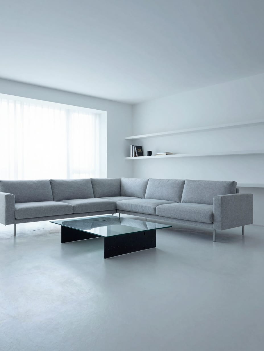 A modern minimalist living room featuring furniture with floating forms, such as a wall-mounted TV console and a leggy sofa.